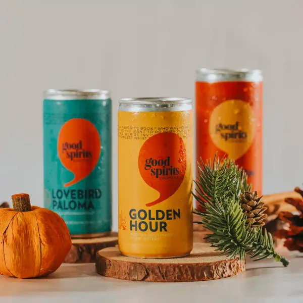A collection of all three Good Spirits Cocktails' canned cocktails adorned by fall decor l pine and pumpkin.